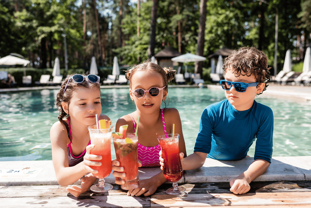 A kids swimming pool with lounge chairs in the background