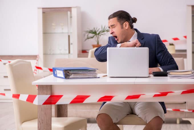 Male employee working at home during pandemic disease
