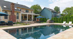 Angled view of yellow and blue house with outdoor swimming pool