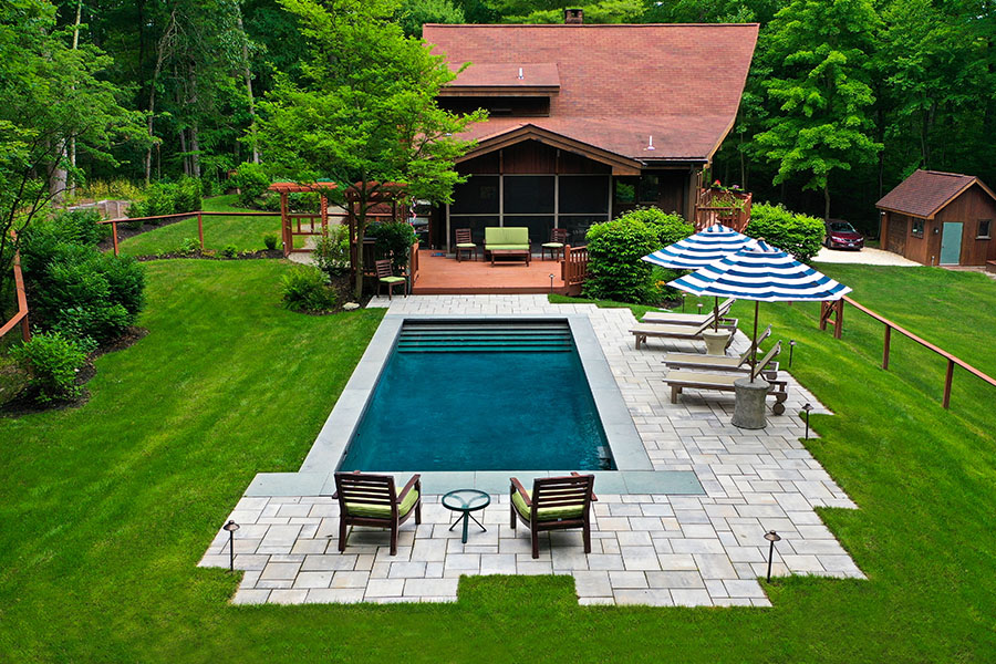 Elegant house with minimalist outdoor pool exemplifying premium new pool installation services in NY and CT Elegant house with minimalist outdoor pool exemplifying premium new pool installation services in NY and CT