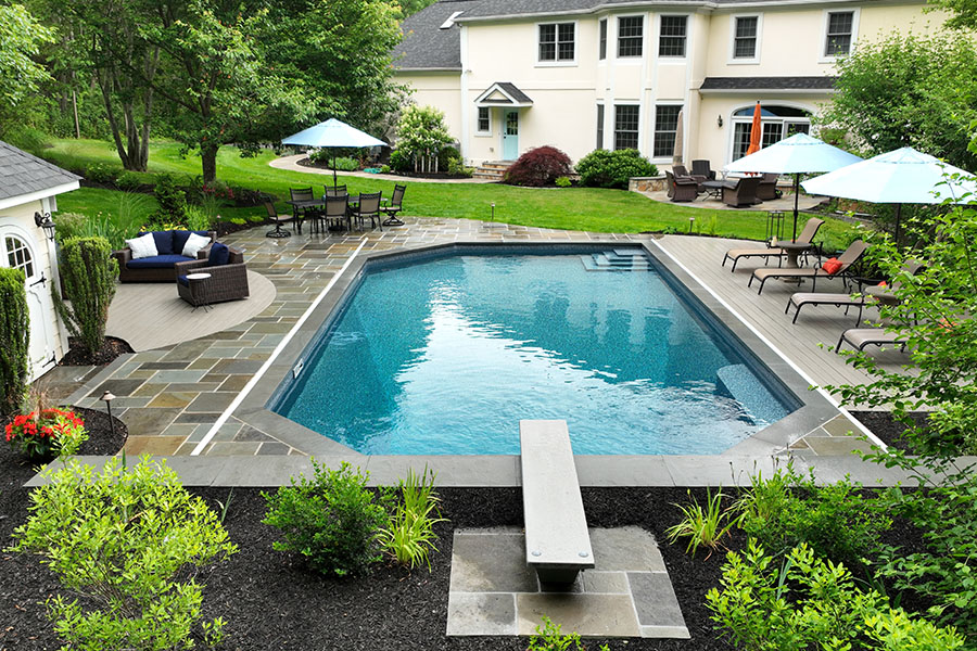 Majestic vinyl pool with a diving board showcasing professional pool installation Majestic vinyl pool with a diving board showcasing professional pool installation