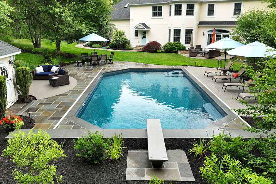 Elegant minimalist pool with clean, clear water, surrounded by stylish pool umbrellas and a sofa set, maintained by NY, NJ, CT pool servicing professionals. Elegant minimalist pool with clean, clear water, surrounded by stylish pool umbrellas and a sofa set, maintained by NY, NJ, CT pool servicing professionals.