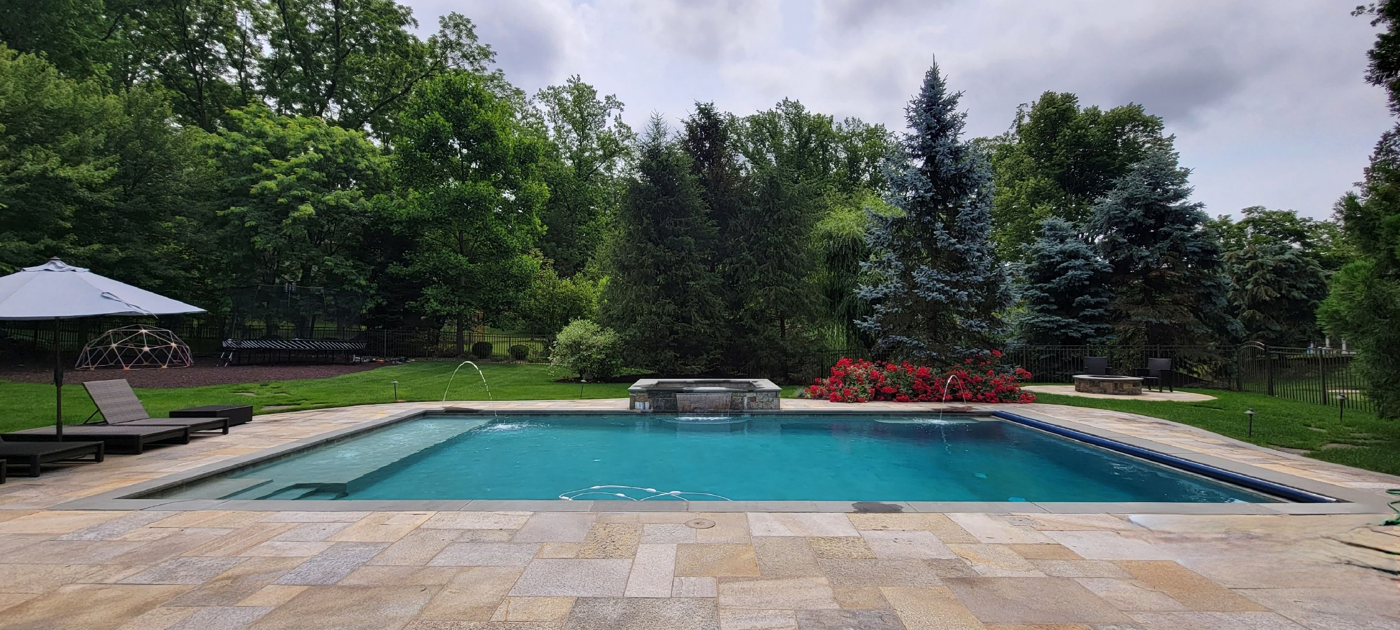 swimming pool size perfect for a backyrad with hardcaped deck around it a pool created according to pool size considerations for the specific backyard area