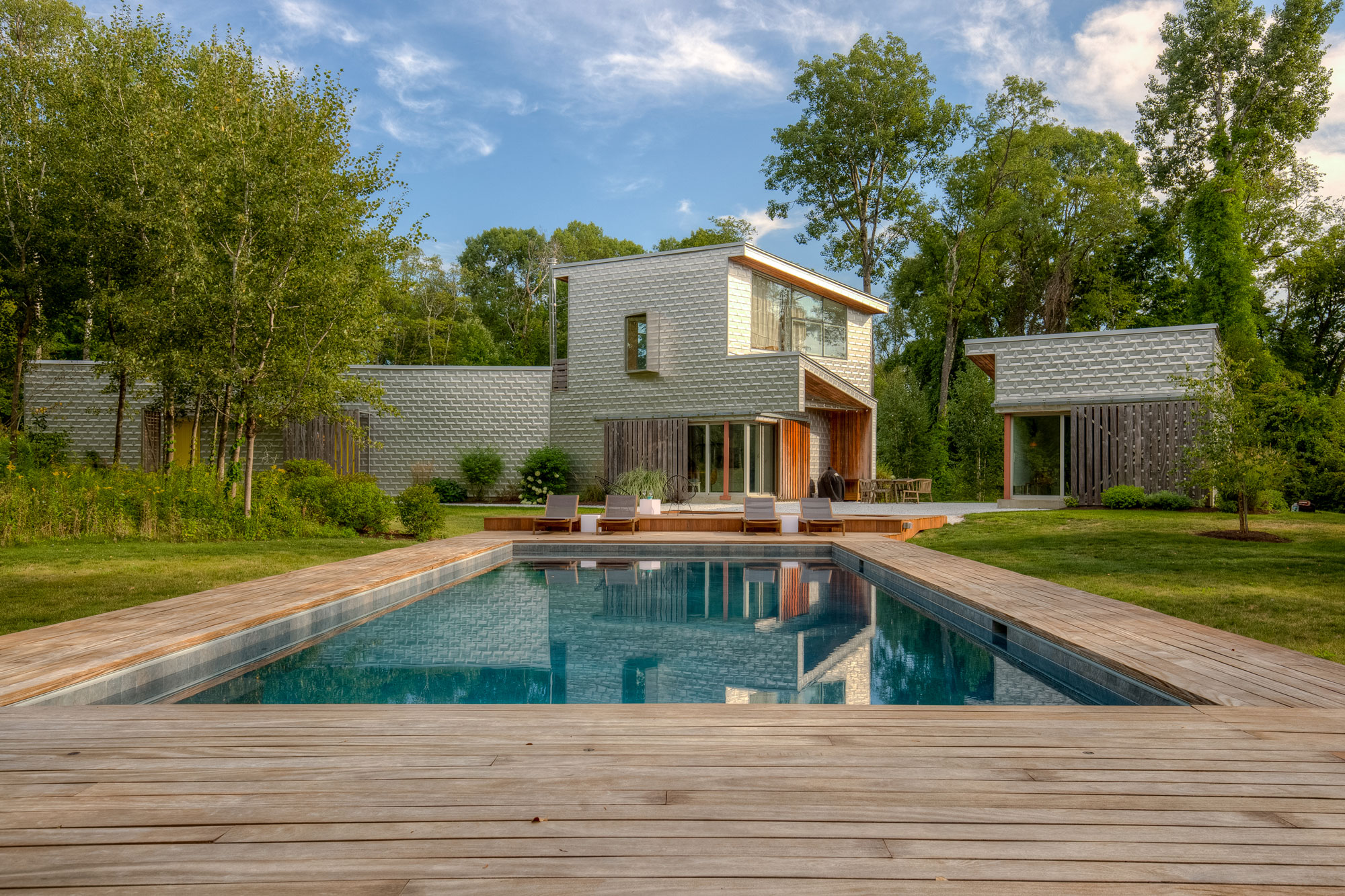 Wooden decking surrounding pool and spa near Westchester New York by Neave Outdoor