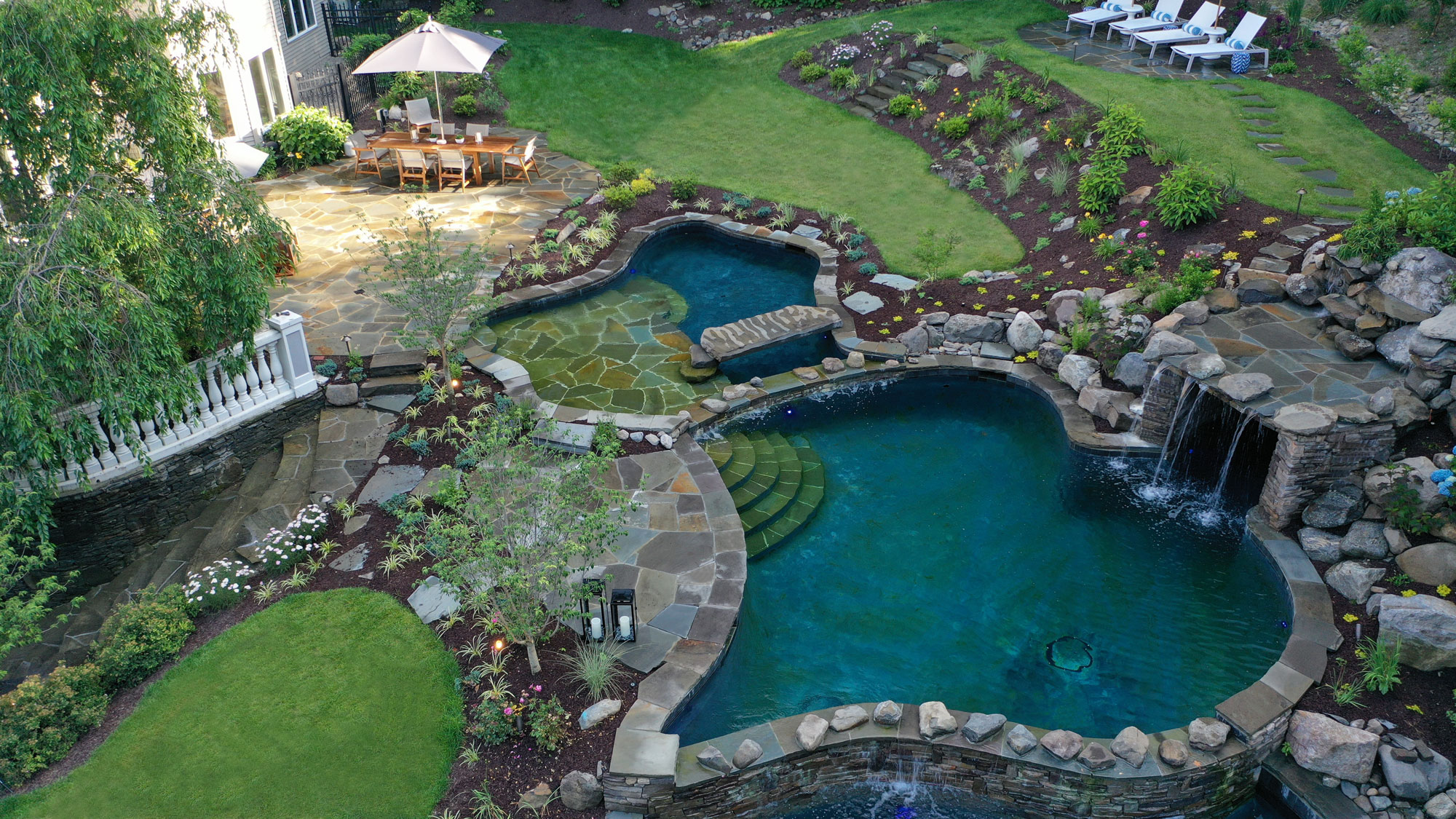 Custom freeform natural pool with built-in spa near Westchester New York by Neave Outdoor